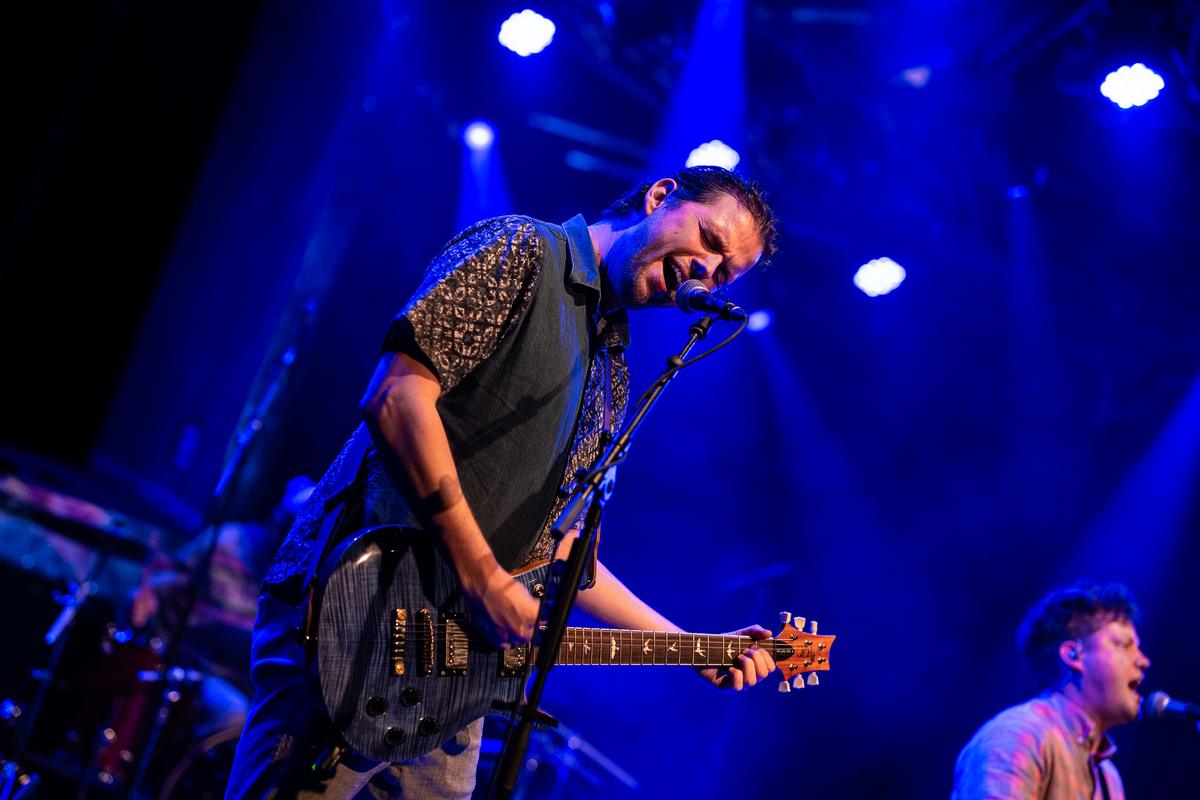 Guitarist in blue light on stage